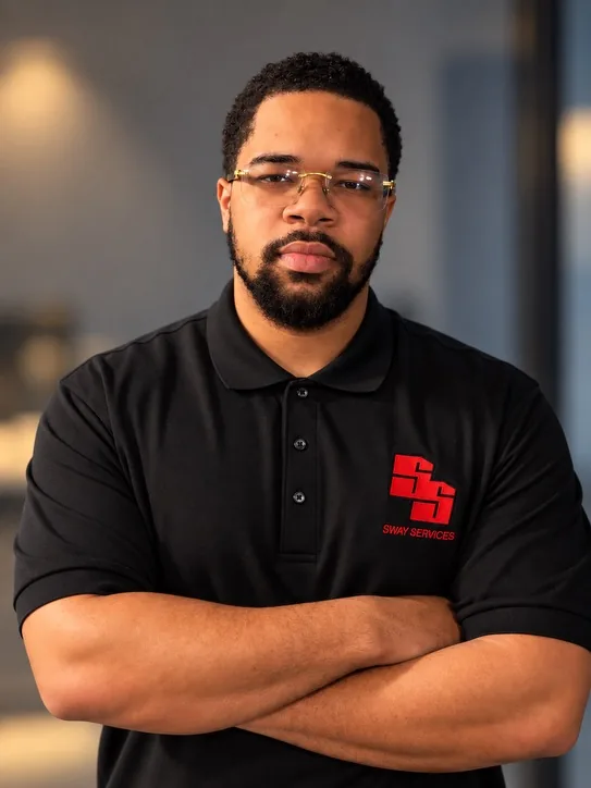 Juan Walker Jr., founder of Sway Services, wearing a black Sway Services polo